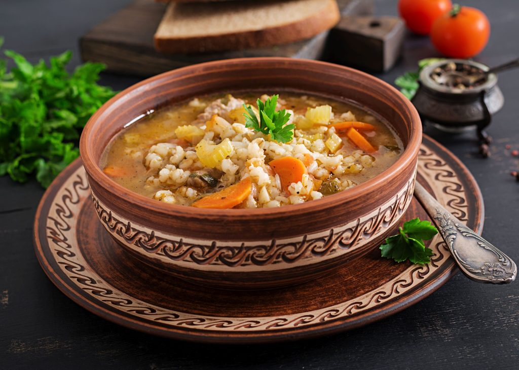 Barley soup with tomato and salted herbs